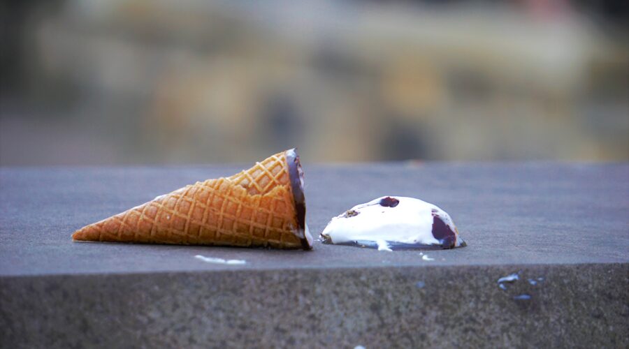 Isn't the ice cream supposed to be *inside* the cone, not sitting beside it on the concrete? That looks accidental…and delicious