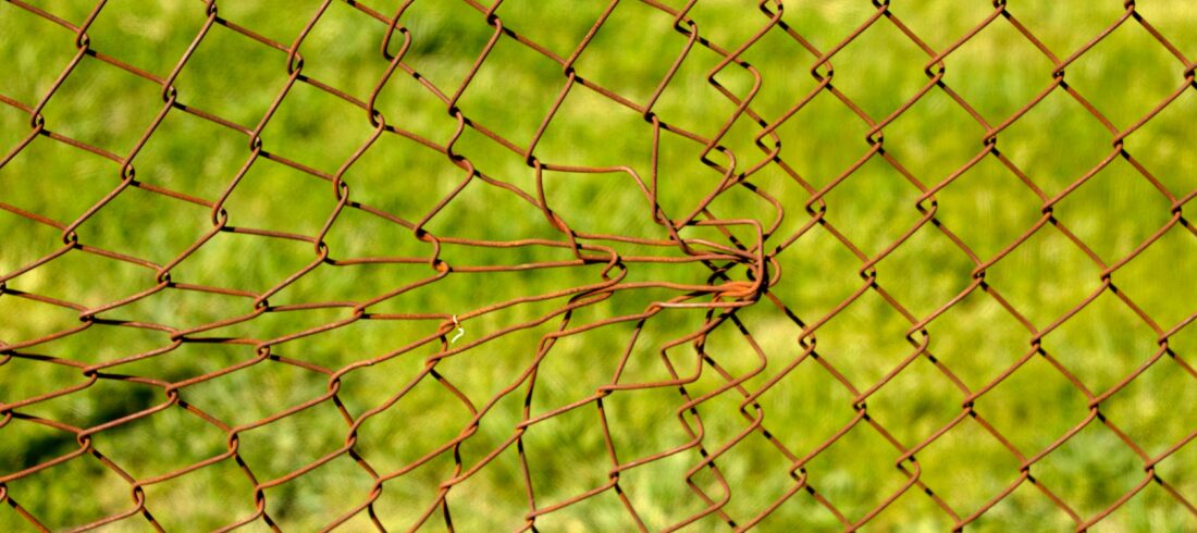 A chain-link fence has been damaged through forceful impact. Hyperlinks, too, provide shape and surface to texts, and they also have expected patterns to follow.